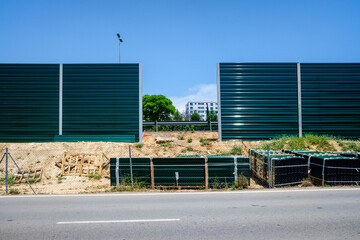 Fototapeta na wymiar Installation of a wall and barrier against the noise of intense traffic on the roads that cross inhabited areas.