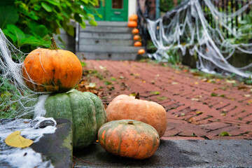 Pumpkins on the steps at the house. Halloween decorations outside. residence front entrance on Halloween. creepy decorations. Copy space for your text