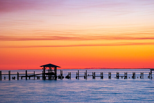 Sunset Beyond Damaged Pier