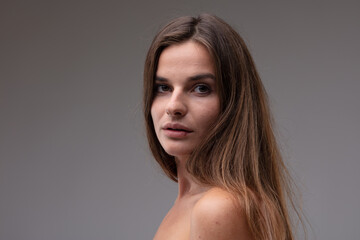 Natural portrait of a sincere young woman looking back