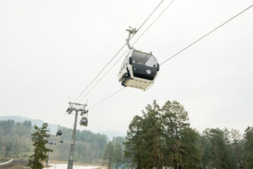 Lift cabins in a mountain ski resort. Ski lift ropeway on hilghland mountain winter resort on...