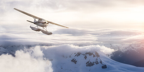 Fototapeta na wymiar Airplane flying near the Beautiful Canadian Mountain Nature Landscape. Adventure Composite. Dramatic Sunset Sky. Background from near Vancouver, British Columbia, Canada.