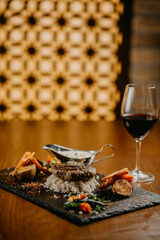 Steak with green butter mushroom sauce and vegetables