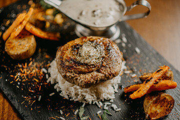 Steak with green butter mushroom sauce and vegetables