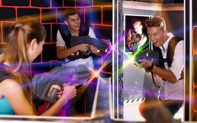 friends with plastic laser pistols in their hands playing laser tag (first-person view).