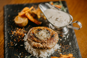 Steak with green butter mushroom sauce and vegetables