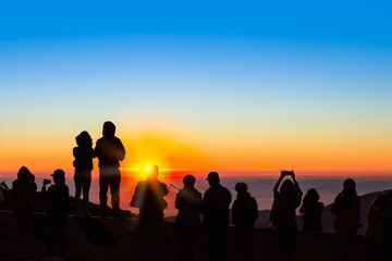 Silhouetted of people with sunrise in northern thailand