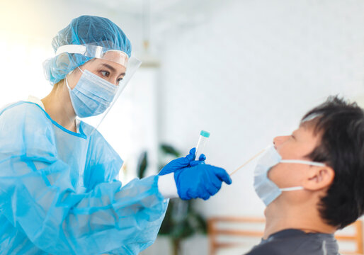 Nurse Or Doctor Wearing Gowns, Masks, Eye Shields, Do Personal Protection, Is Taking Swabs For Patients