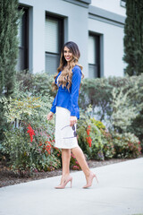 Young woman posing smiling in the street in the city.