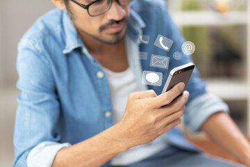 hand of man holding mobile phone with call, email, line and message icon, contact and customer support concept
