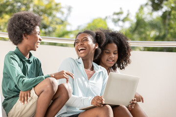 A group of afro children  curly hair style conversation conversation and using laptop at staircase of building.