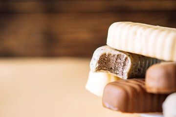 Still life of chocolate popsicle lying on a plate on a wooden background table. Copy space