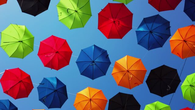 Malta, Zabbar, umbrella street, spinning under the umbrellas with clear blue sky in the back.