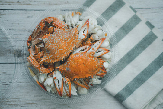 Steamed Blue Crab Legs In Circle Box On Wooden Board Background.