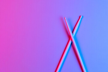 Drum sticks in neon light. Template Copy space for text