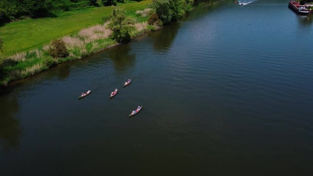 Tourists on boats with oars float along the river in a beautiful place