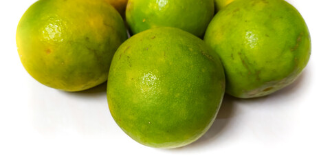 Fresh green oranges neatly arranged above on a white background. green orange isolated with copy space suitable for landing page or website.