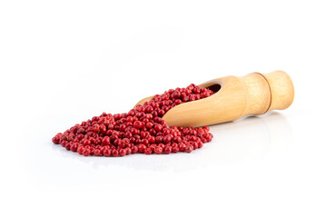 Wooden scoop with different pepper grains on white background, dried pink peppers isolated on white, dried pink peppercorns isolated on white