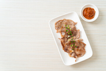 grilled pork neck sliced on plate
