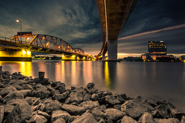 Blurred abstract background of shadows reflecting the lights from the bridge (bangkok Bridge) under the park, crowded out and enjoying the evening view in Bangkok, Thailand.