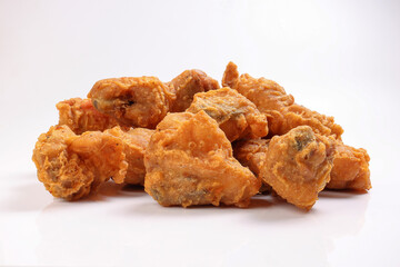 Light battered deep fried chicken variety mix pieces pile on white background healthy fry