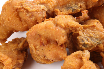 Light battered deep fried chicken variety mix pieces pile on white background healthy fry