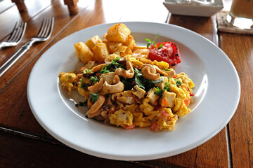Stir fry omelet egg with squid, cashew nut and potato wedge