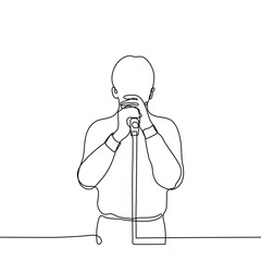 man in a shirt and trousers holding a microphone - one line drawing. singing singer concept, stand-up comedian monologue, orator speaking