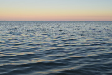 slow shutter view of bay waves and horizon at dusk