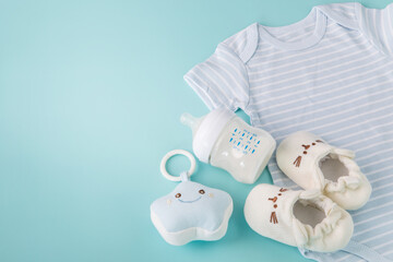 Composition with a baby accessories on light blue background , new born or baby care concept