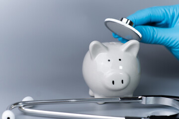 Health check piggy bank with medical tools.concept of financial stability Build good immunity in investment..Prevent the loss of investment from the crisis caused by the coronavirus covid-19