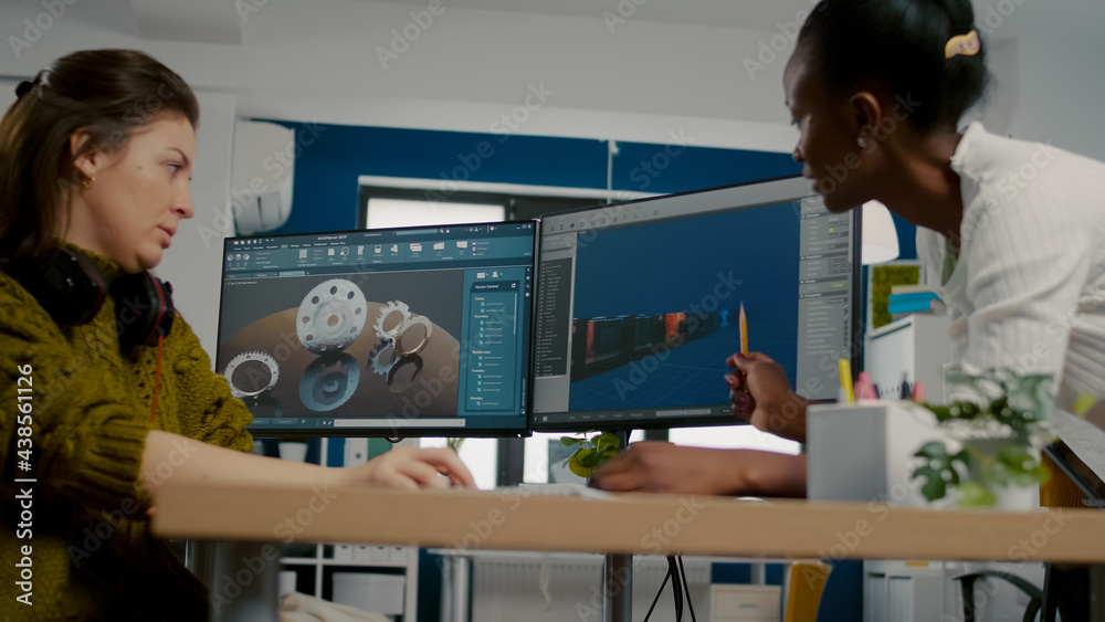 Wall mural diverse women game software developers creating game interface sitting in startup creative agency co