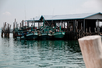 Fototapeta na wymiar Traditional Khmer fishing boats moored at the harbor of Koh Sdach Island in Cambodia