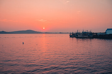 Fototapeta na wymiar Scenic view of Khmer fishing boats in the harbor of Koh Sdach Island in Cambodia during sunset