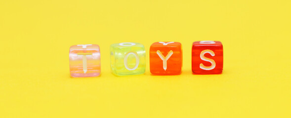 Word toys with colorful cubes of beads on yellow. banner