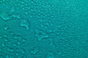 Blue aqua shimmer glitter wet texture with drops and ripple. Fresh lagoon abstract background.