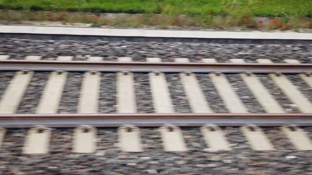 View on railroad track from the window of fast train, 300 km hour . Bullet train rides on the railway track. 4K