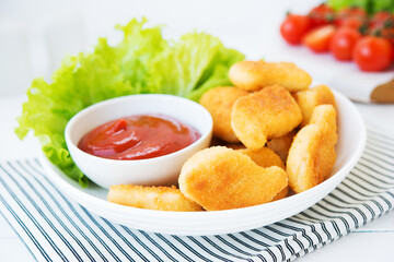 Chicken nuggets with sauce and herbs in a plate, selective focus