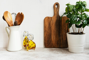 Kitchen utensils, tools and dishware on on the background white tile wall.
