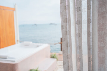 Fototapeta na wymiar Close-up photo of white curtains and sea view background.