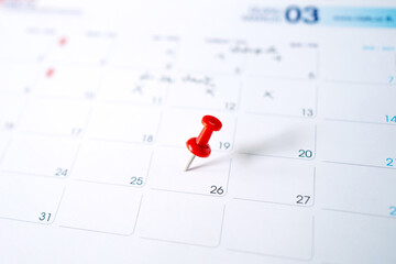 Selective focus. A photo of a calendar with a red pin on March 26.  Concept of to do planning.