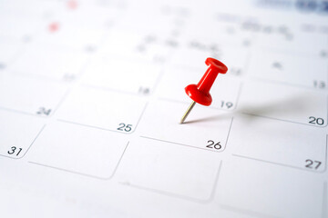 Closeup red pin on the calendar. Calendar with red pins on the 20th, mark the date of the event with a pin.