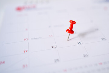 Calendar with a red pin on the 19th, mark the date of the event with a pin.