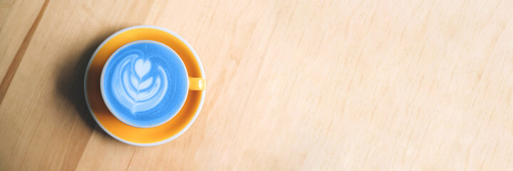Banner with blue matcha art on wooden background.