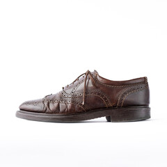 old worn brown men's brogues on a white background close-up side view. classic men's shoes. mockup