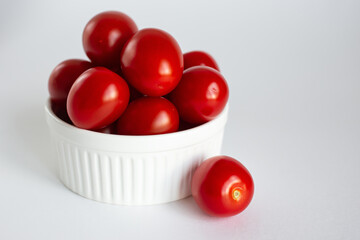 Red ripe tomatoes on a white background.