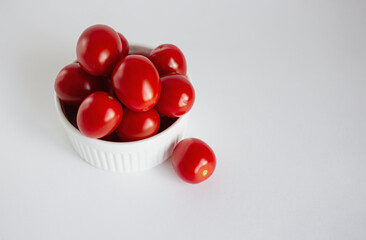 Red ripe tomatoes on a white background.