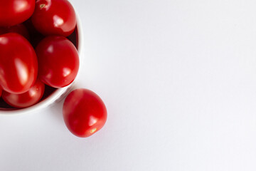 Red ripe tomatoes on a white background.