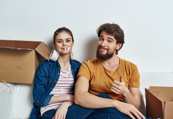 Young family sitting on couch boxes with stuff moving fun