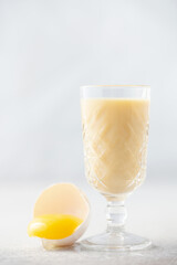 Egg alcohol liqueur in a glass. Festive drink.